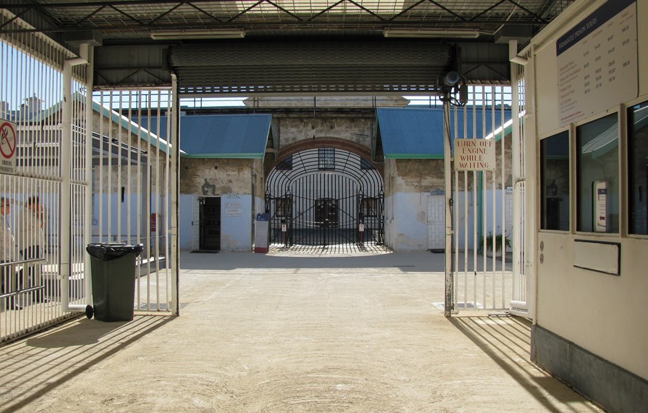 Wide undercover entrance into Gatehouse complex with limestone buildings and Prison in background